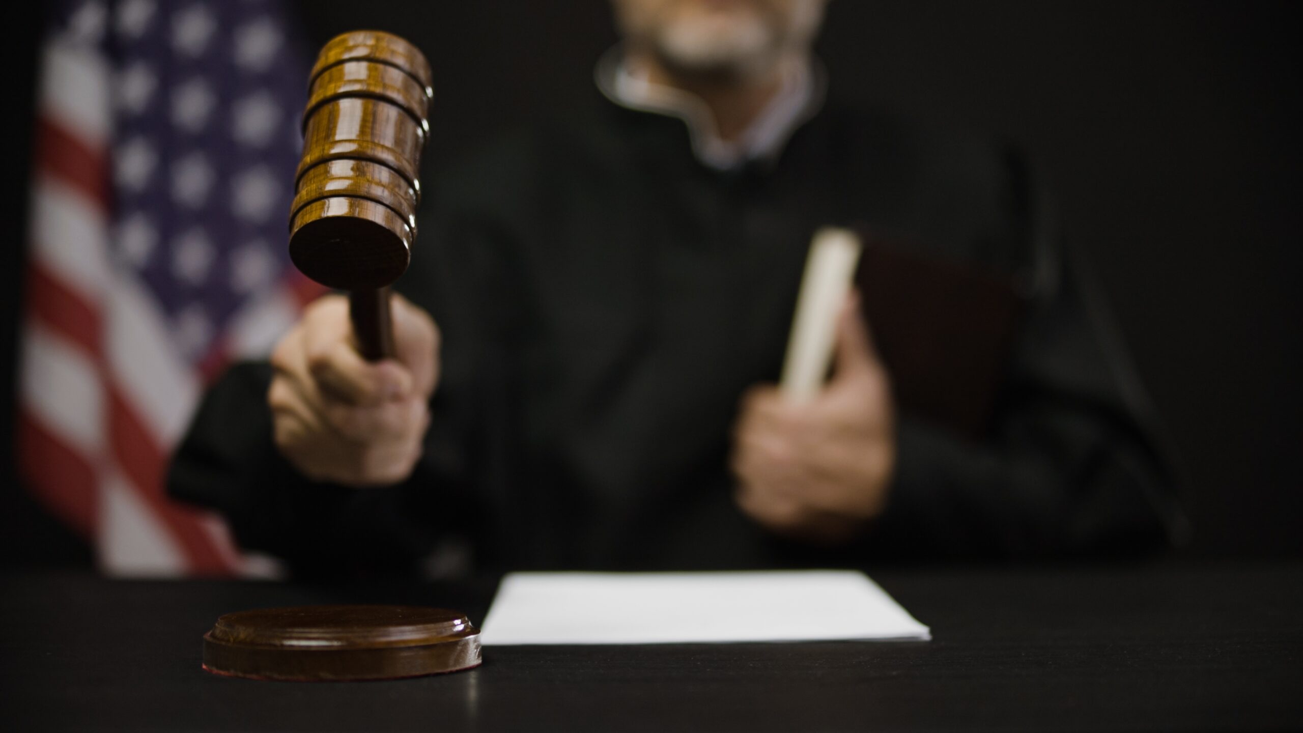 pleading guilty; male judge hitting gavel