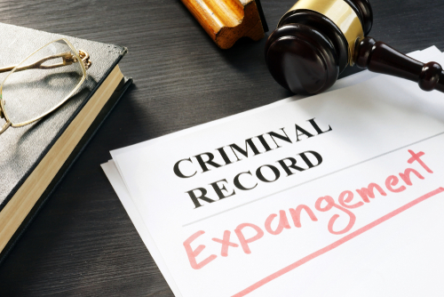 criminal record expungement written on a paper beside gavel and book