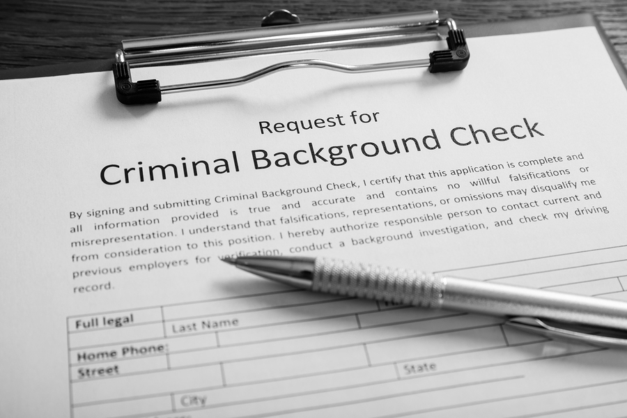 Close-up Of Criminal Background Check Application Form With Pen At Desk