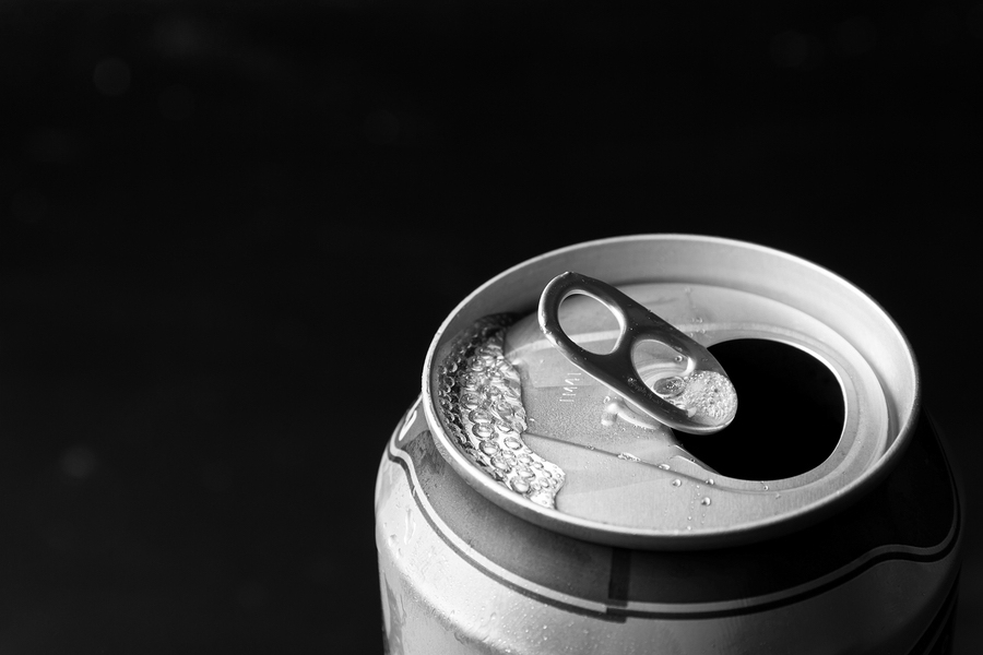 Close up of opened beer can on a black background.