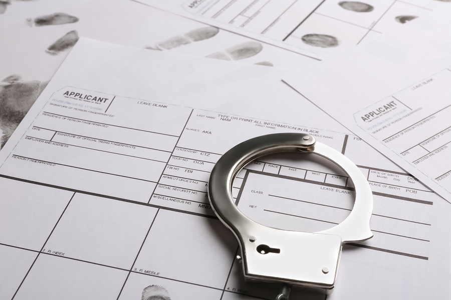 Handcuffs And Fingerprint Record Sheets, Closeup. Criminal Inves