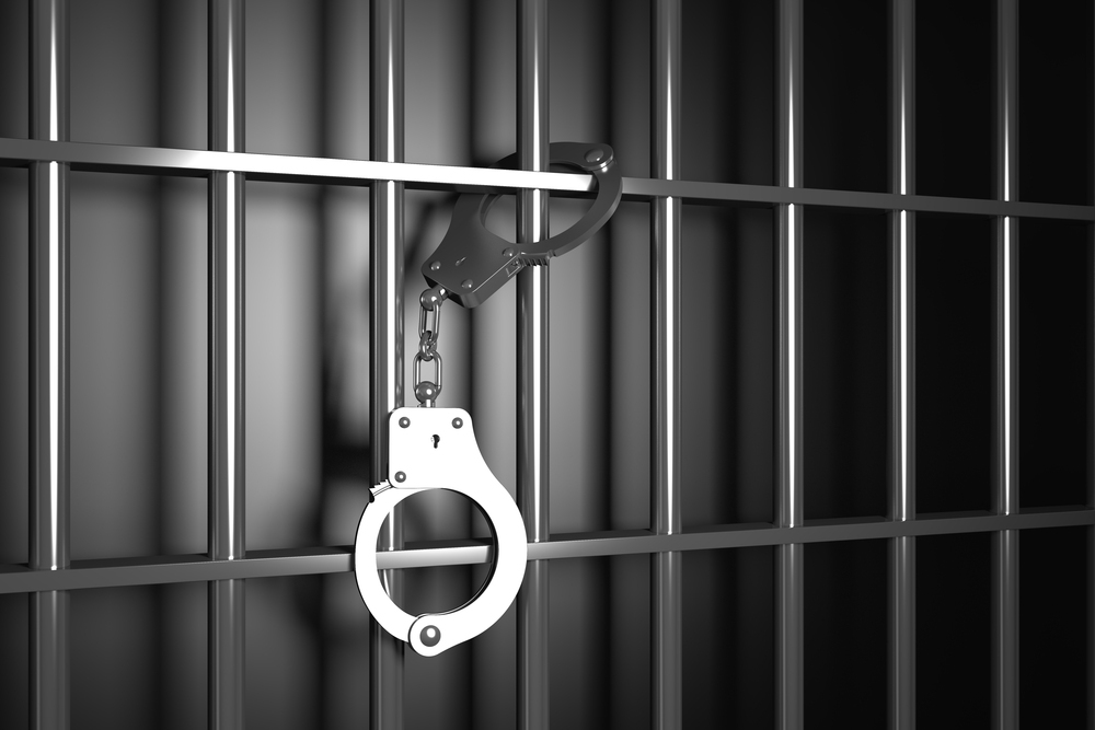 handcuffs on prison bars